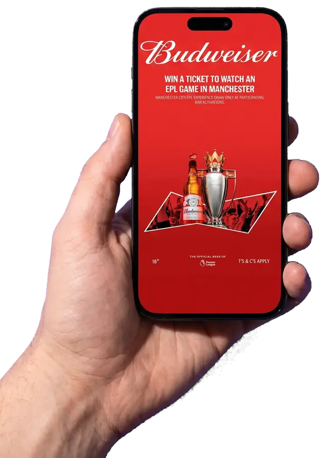 A hand holds a phone showing the real Budweiser campaign screen: win a ticket to a football match.